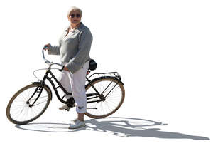 backlit older woman with a bike