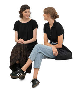 two cut out women sitting and talking casually