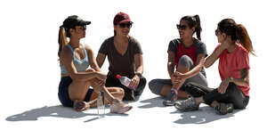 group of women in sport outfits sitting in a circle