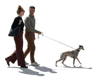 cut out backlit man and woman walking a dog