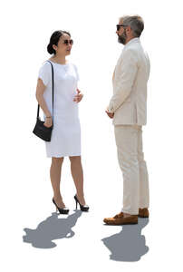 backlit man and woman in elegant white summer outfits standing