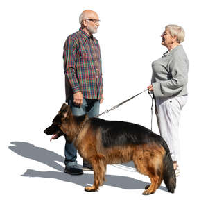 two elderly people with a dog standing