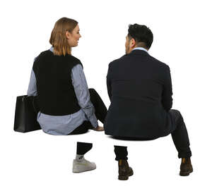 two people sitting and talking in an office environment