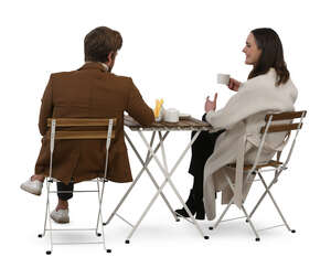 back view of a man and woman sitting in a cafe