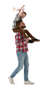 boy sitting on his fathers shoulders and flying a toy plane