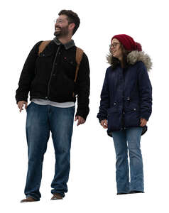 two cut out people standing in winter seen from below