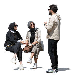man talking to two young muslim women