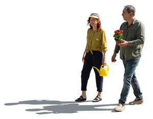 two backlit senior people going to plant flowers