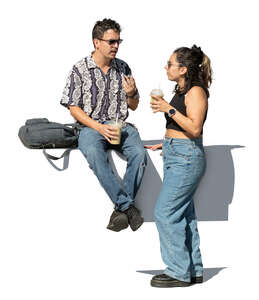 man and woman eating and drinking in the street