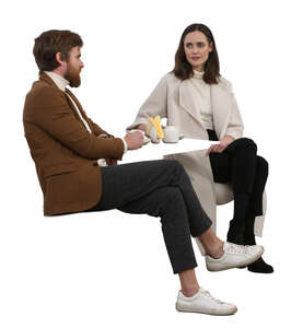 two cut out  people sitting in a coffee house