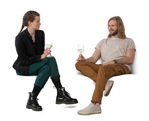 two people sitting on a sofa and drinking wine