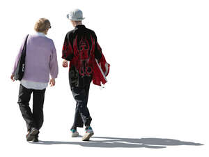 two backlit people walking