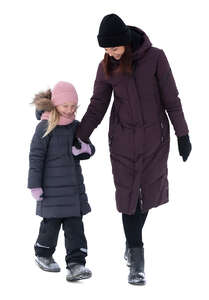 cut out woman and child walking hand in hand on a winter day
