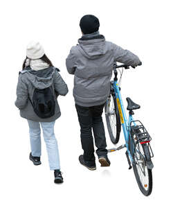 top view of two people in autumn walking with a bike