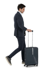 man in a suit walking with a suitcase
