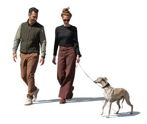 man and woman walking a dog