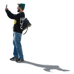 cut out backlit man standing and taking a picture