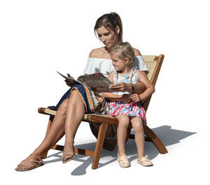 woman sitting in an armchair with her daughter and reading a magazine