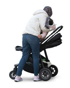 muslim woman putting her child in the stroller