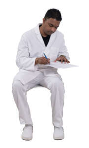 indian doctor sitting and writing