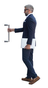 cut out man in a suit opening a door