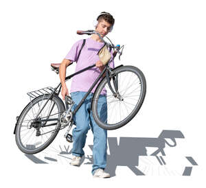 teenage boy walking down the stairs and carrying a bicycle