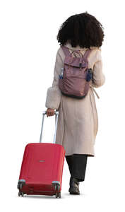 woman pulling a red suitcase walking