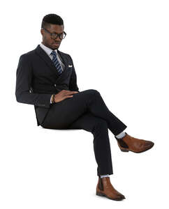 cut out black man in a dark suit sitting