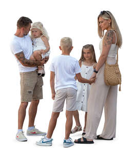 family with three children standing in summer