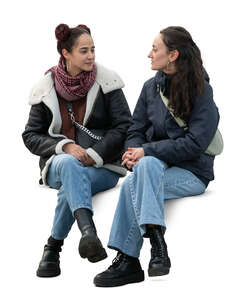 two women sitting in spring and talking