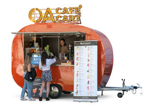 two women buying ice cream from a food trailer