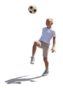 cut out backlit little boy playing with a football