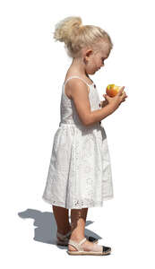 cut out little girl in a white dress eating an apple