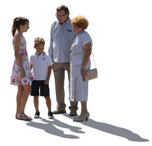 backlit grandparents and grandchildren standing