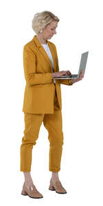 cut out woman in a yellow business costume standing and holding a laptop