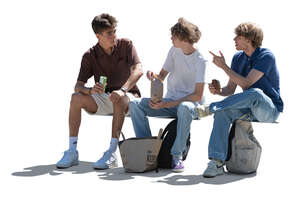 three cut out backlit teenage boys sitting and eating sandwiches