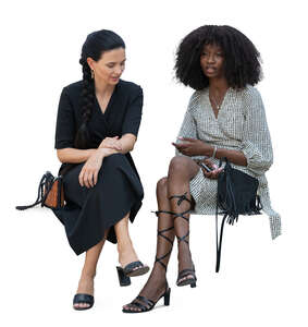 two women at a party sitting and talking