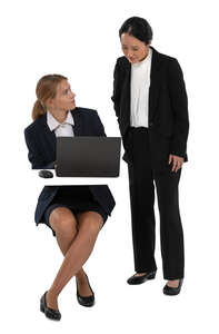 cut out businesswoman walking to another woman sitting behind the computer