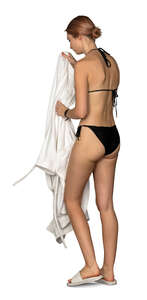 woman in a spa taking off her bathrobe