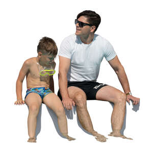 father and son sitting at the edge of the pool