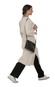 woman in a white overcoat walking