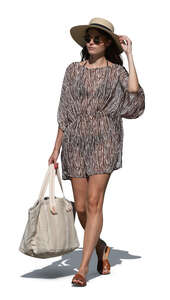 woman in a light dress going to the beach