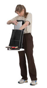 female student taking books out of the backpack