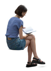cut out woman sitting and reading a book