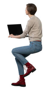 woman working with laptop sitting behind the counter height table