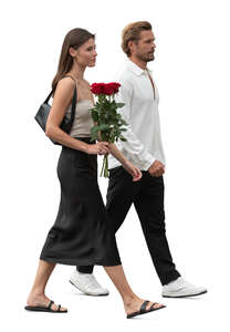 couple with a bouquet of flowers walking