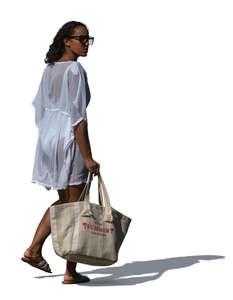 cut out woman in a light beach dress going to the beach