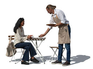 cut out waiter serving coffee to a woman sitting in a cafe