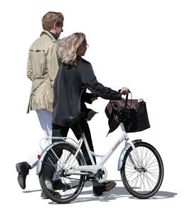 man and woman with a bike walking on a windy day
