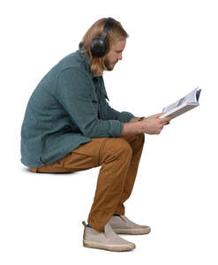 man sitting and reading a book